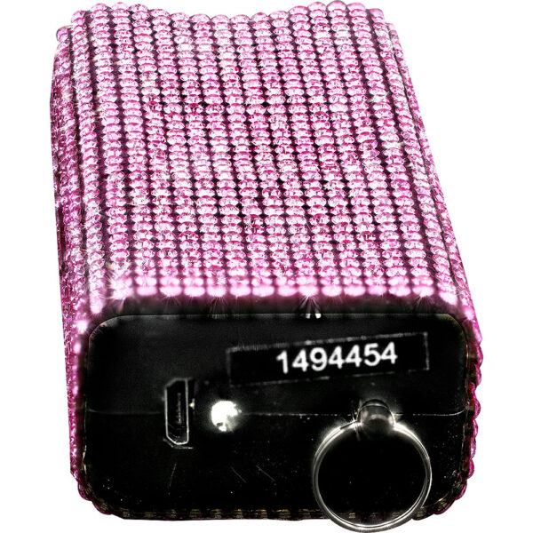 The image shows a rectangular portable device covered in pink rhinestones. The surface is entirely encrusted with shiny, reflective gems arranged in a grid pattern, giving it an elegant and glamorous appearance. The device appears to have a USB port and a keyring attached at one end, indicating it might be a charger or a similar portable electronic. The number