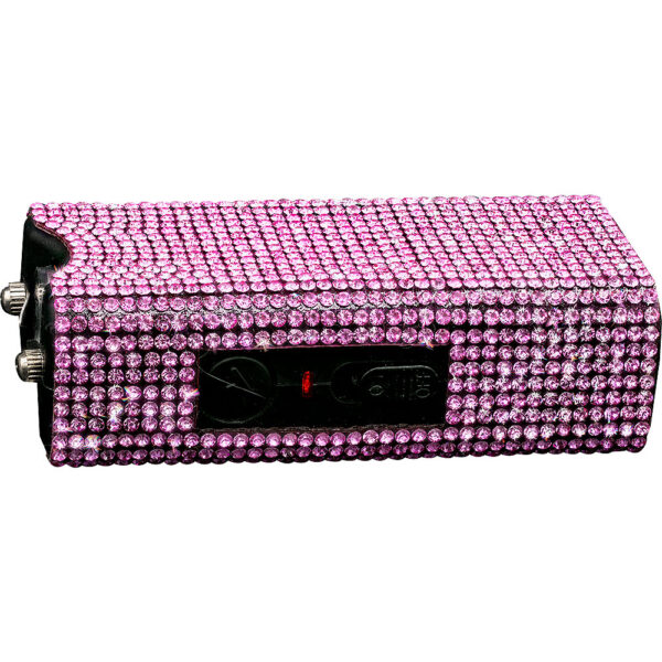 This image features a handheld device with a compact rectangular shape, embellished with a covering of pink rhinestones, giving it a sparkling and glamorous appearance. The device has a black surface with a visible switch and a light indicator. The embellishment includes densely packed rhinestones that uniformly cover the top, sides, and bottom, enhancing its aesthetic appeal. The connectors