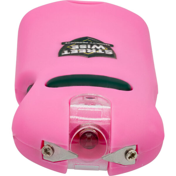 The image displays a pink personal alarm device known as Street Wise Security Products. This compact safety tool features a robust pink casing and is designed for personal security. It includes a siren hole for sound emission and two metal prongs at the front, which likely suggest a built-in defense or alarm mechanism. The device is small and portable, making it