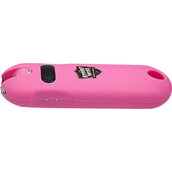 This image features a pink personal safety device known as a stun gun. The design is compact and sleek, resembling a modern electronic gadget. The device has a black power button located on its side for easy activation. The brand logo Street Wise is prominently displayed on the surface. The body of the stun gun is smooth, with a rounded edge and