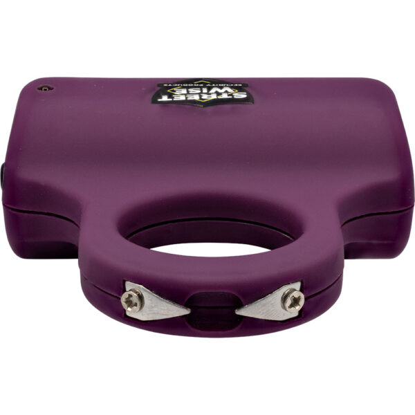 The image features a compact, handheld personal safety device, specifically a purple stun gun with a distinctive finger grip design for secure handling. The device is made of durable plastic, and its compact size suggests portability. The surface includes a label with the brand name Streetwise. The bottom of the device showcases two small metal prongs, indicative of its function