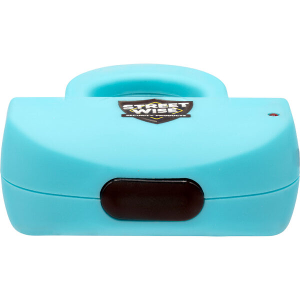 The image features a small, compact personal security alarm in a vibrant blue color. The device is rectangular with rounded edges and has a black button located on the front. There's a logo on the top, reading Street Wise Security Products, which is shield-shaped and prominently displayed. The alarm likely serves as a safety or self-defense tool, portable enough to