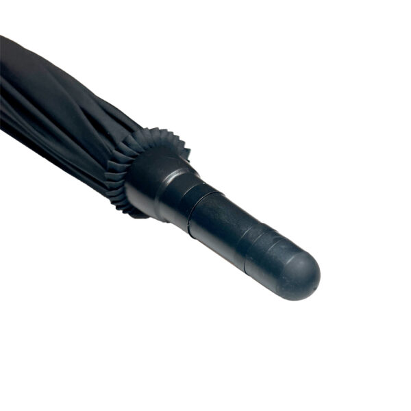 Close-up image of the tip of a black umbrella, showcasing its compact and sleek design. The umbrella is in a folded state, highlighting the tightly wrapped black fabric and the ribbed detailing of the tip. The black handle features a smooth, rounded end with subtle ridges, emphasizing the umbrella's sturdy construction. Perfect for enhancing content related to travel accessories